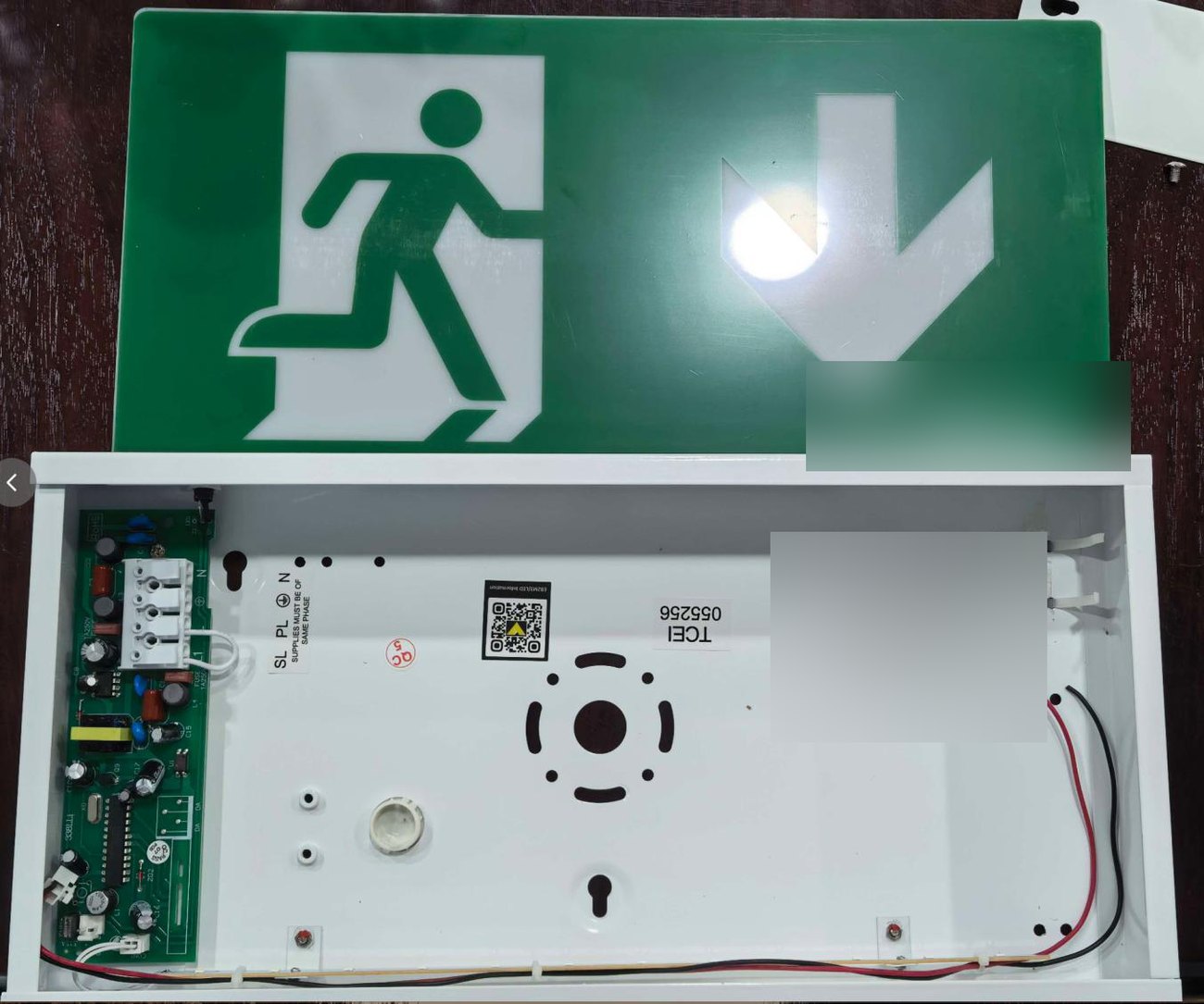Exit sign box opened showing internal tray